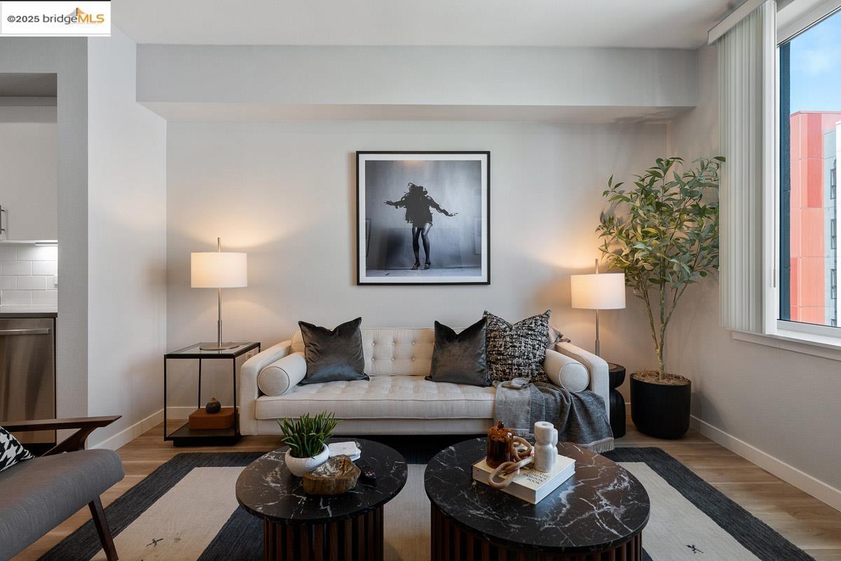 260 Brooklyn Basin Way, Unit 428 Oakland, CA 94606 - Photo 2 of 44 Living room featuring wood finished floors and healthy amount of natural light