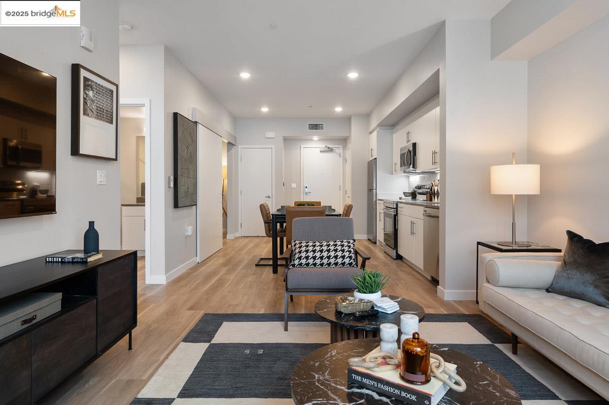 260 Brooklyn Basin Way, Unit 428 Oakland, CA 94606 - Photo 4 of 44 Living area with light wood-style floors and recessed lighting