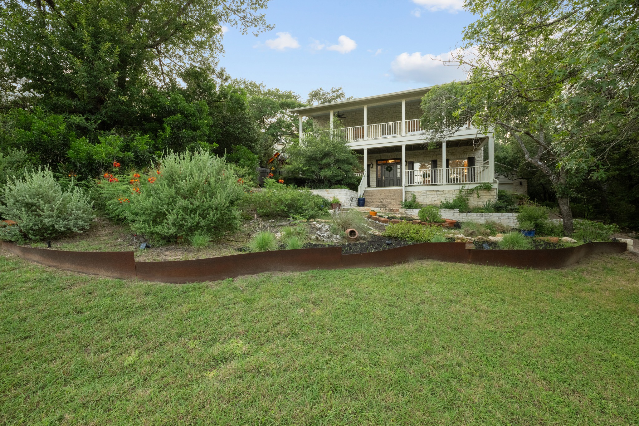 6004 Mt Bonnell Road Austin, TX 78731 - Photo 2 of 24 a front view of a house with a yard
