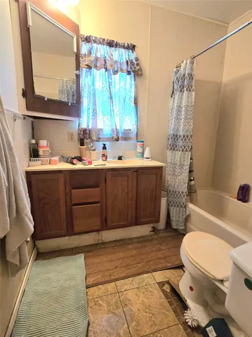 a bathroom with a sink a toilet and tub