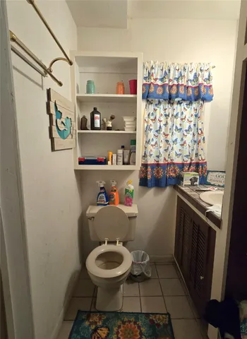 a bathroom with a toilet and a shower curtain