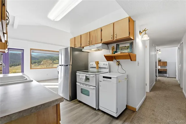 a view of a kitchen with storage and utility room