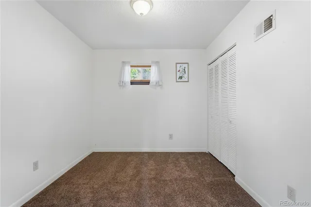 a view of a room with a sink and a mirror