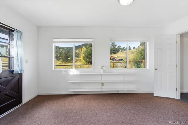 a bathroom with a shower curtain and a window