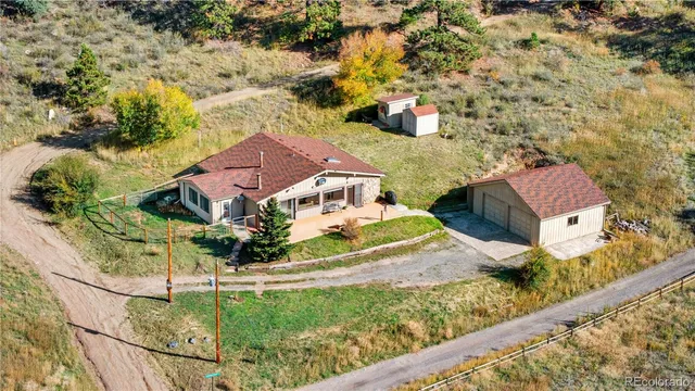 a view of a white house with a yard patio and couches