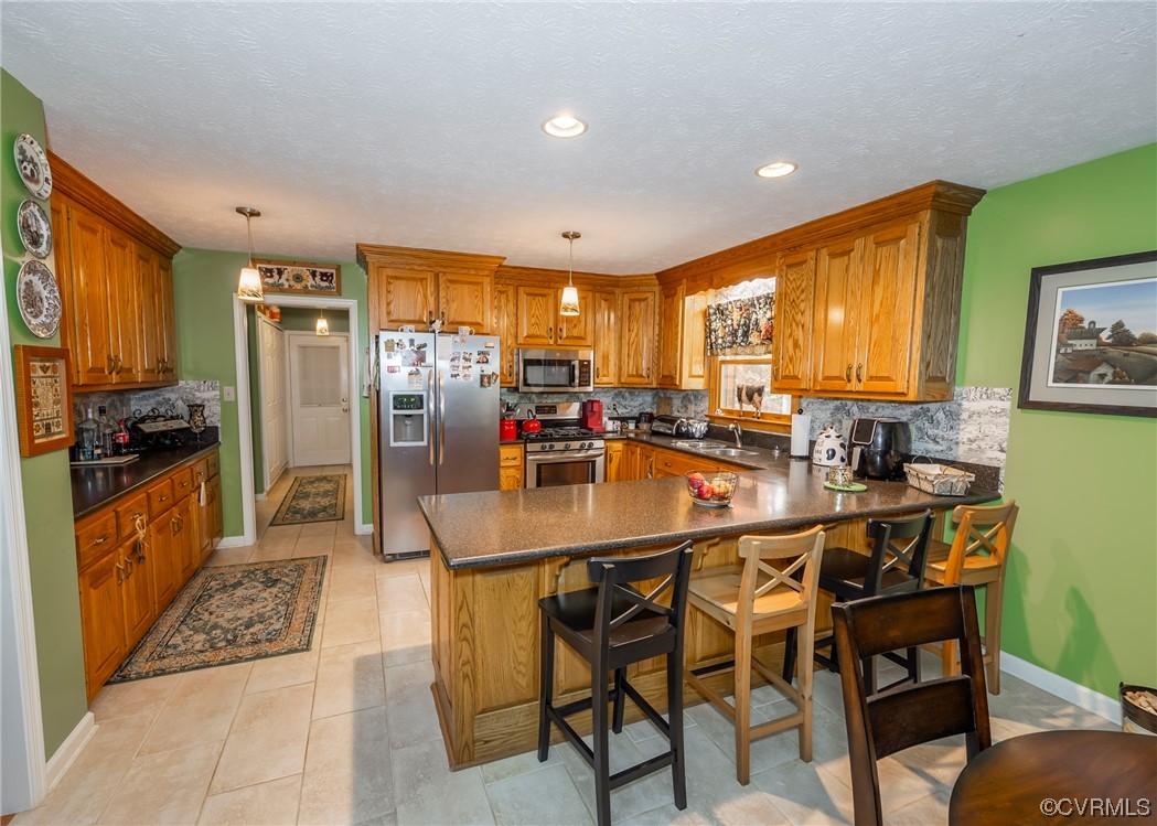 175 Walton Road Keysville, VA 23947 - Photo 28 of 49 a kitchen with stainless steel appliances granite countertop a table chairs and a refrigerator