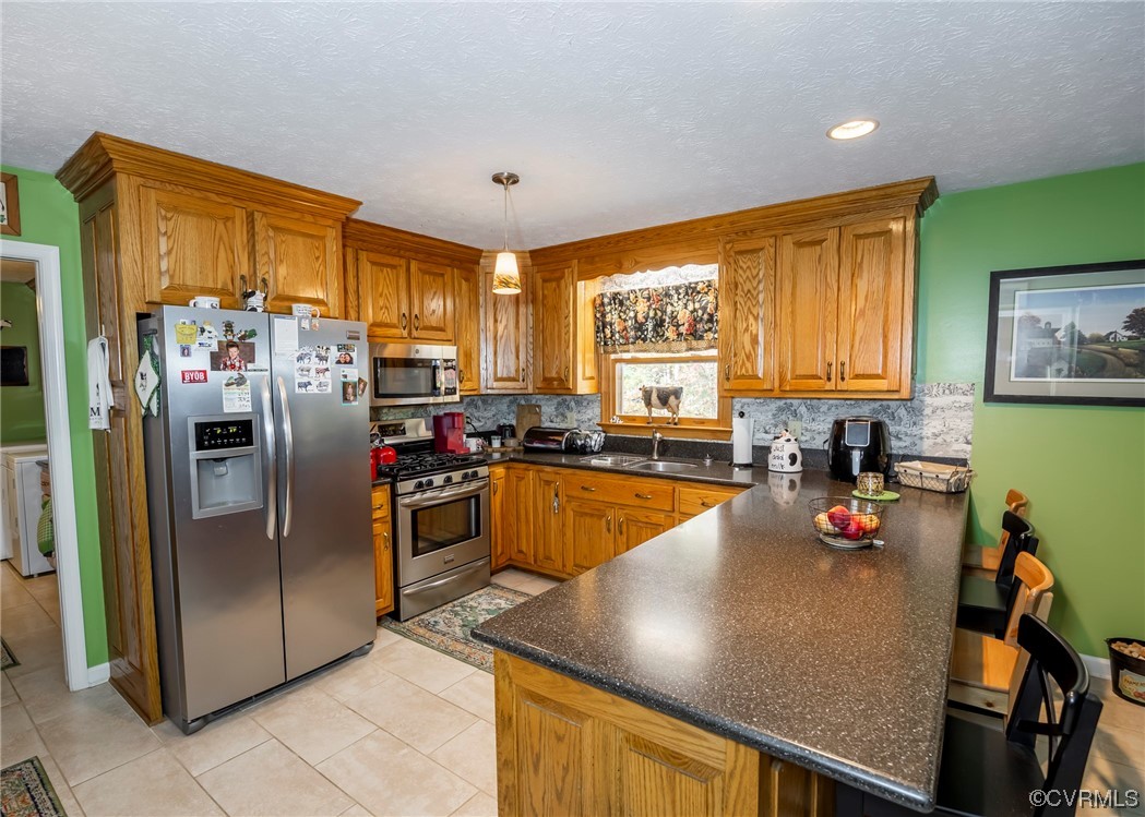175 Walton Road Keysville, VA 23947 - Photo 29 of 49 a kitchen with stainless steel appliances granite countertop a refrigerator a sink a stove and island