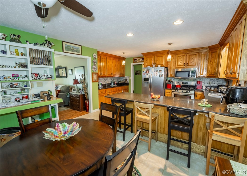 175 Walton Road Keysville, VA 23947 - Photo 31 of 49 a open kitchen with stainless steel appliances kitchen island granite countertop a table and chairs in it
