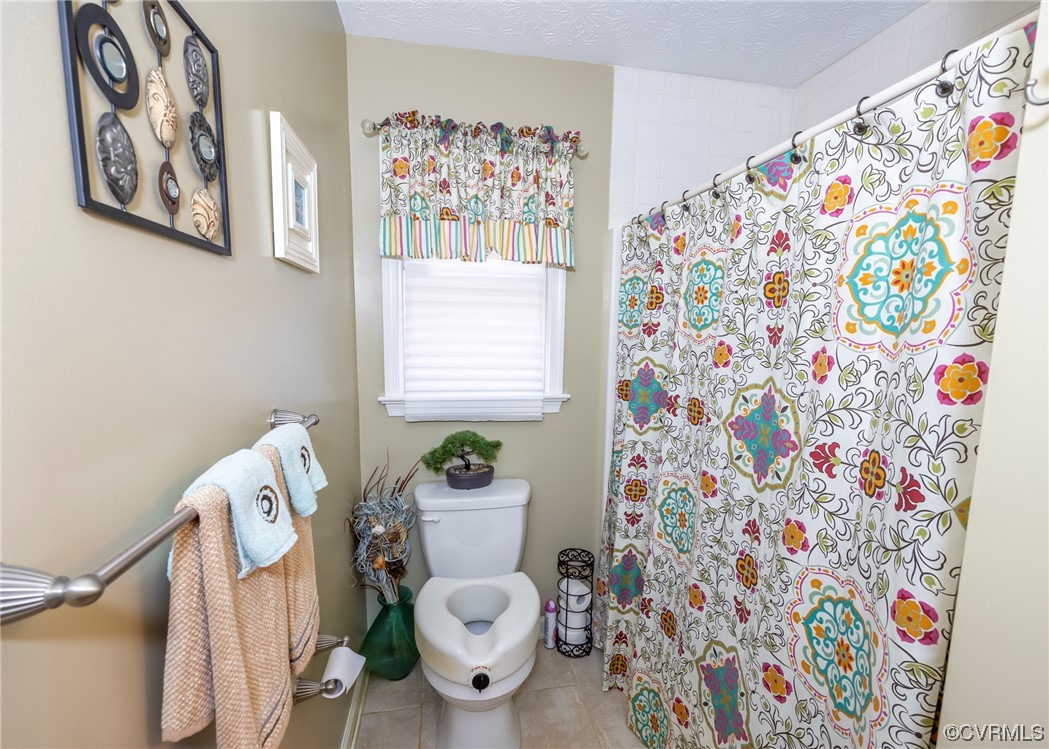 175 Walton Road Keysville, VA 23947 - Photo 40 of 49 a white toilet sitting next to a shower curtain