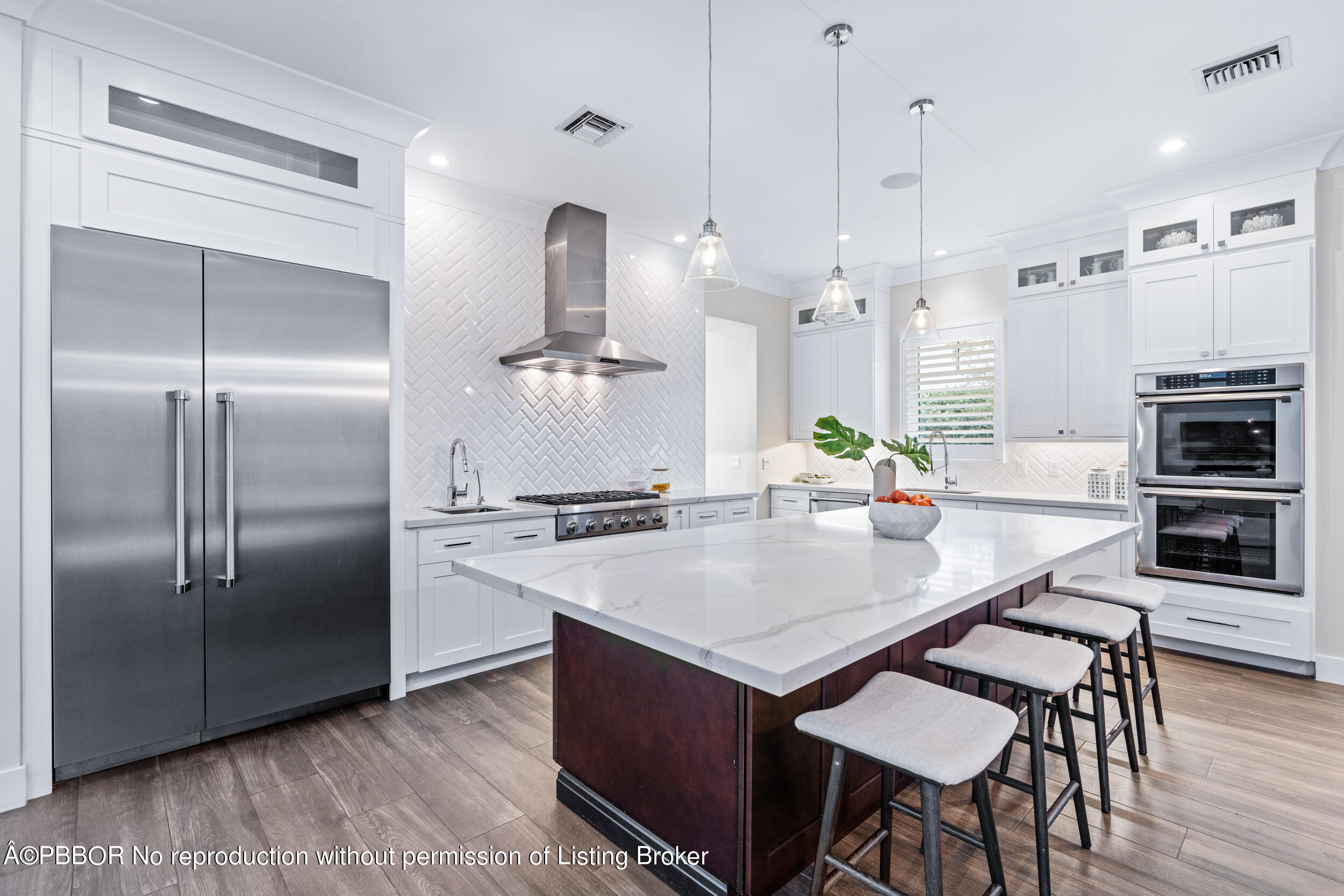 234 Desota Road West Palm Beach, FL 33405 - Photo 11 of 36 a kitchen with stainless steel appliances kitchen island granite countertop a refrigerator a stove a kitchen island a dining table and chairs with wooden floor