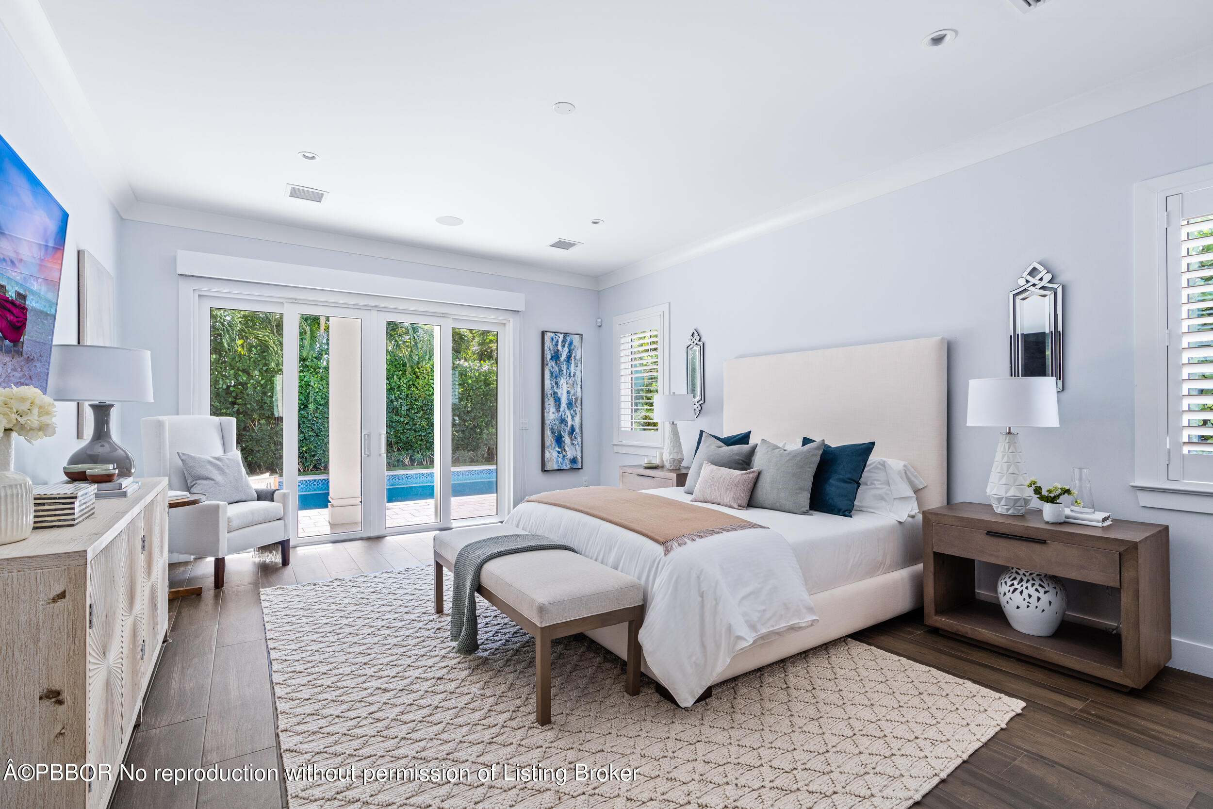 234 Desota Road West Palm Beach, FL 33405 - Photo 16 of 36 a bedroom with a bed wooden floor and lamp