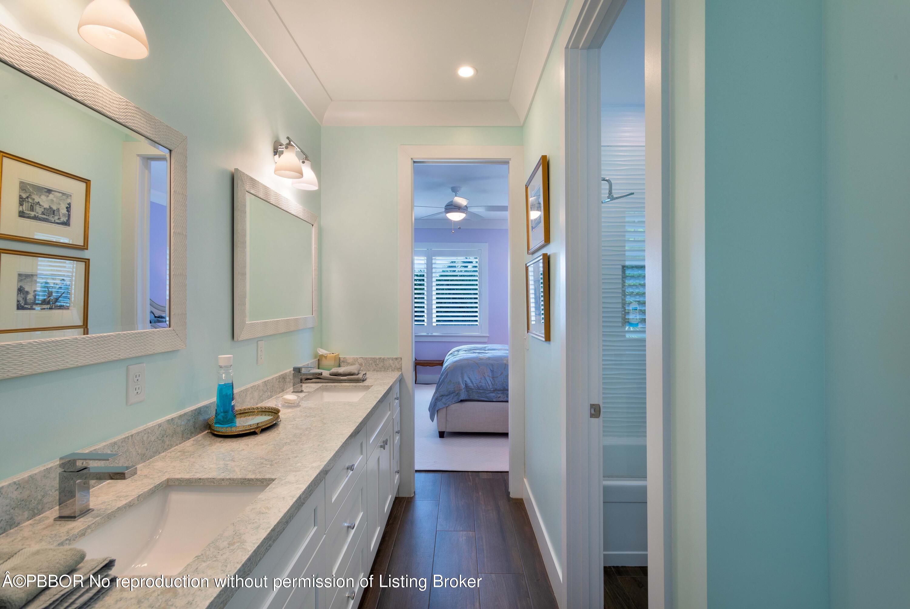 234 Desota Road West Palm Beach, FL 33405 - Photo 23 of 36 a bathroom with double vanity sinks and a mirror