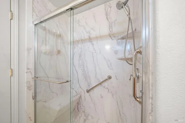 a bathroom with a glass shower door