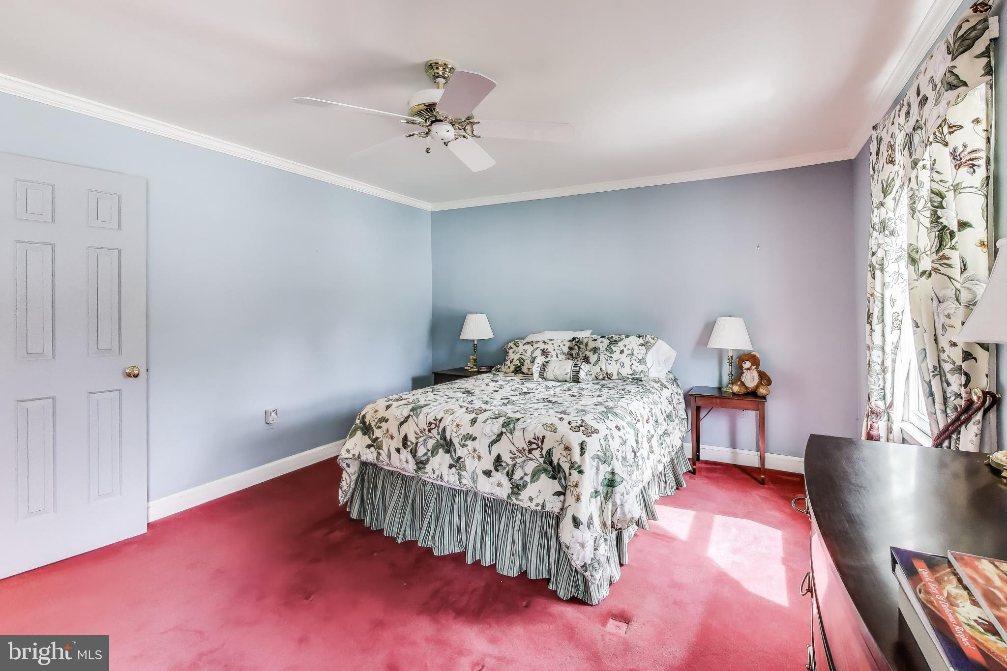 9201 Centerway Road Gaithersburg, MD 20879 - Photo 17 of 53 a bedroom with a bed and a chandelier