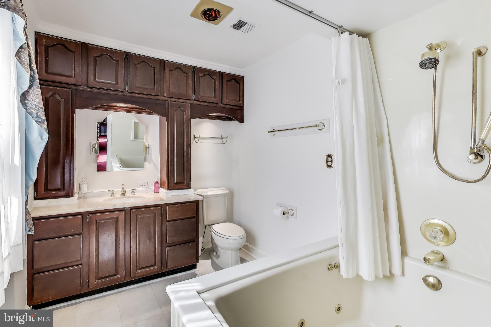 9201 Centerway Road Gaithersburg, MD 20879 - Photo 19 of 53 a bathroom with a tub sink and mirror