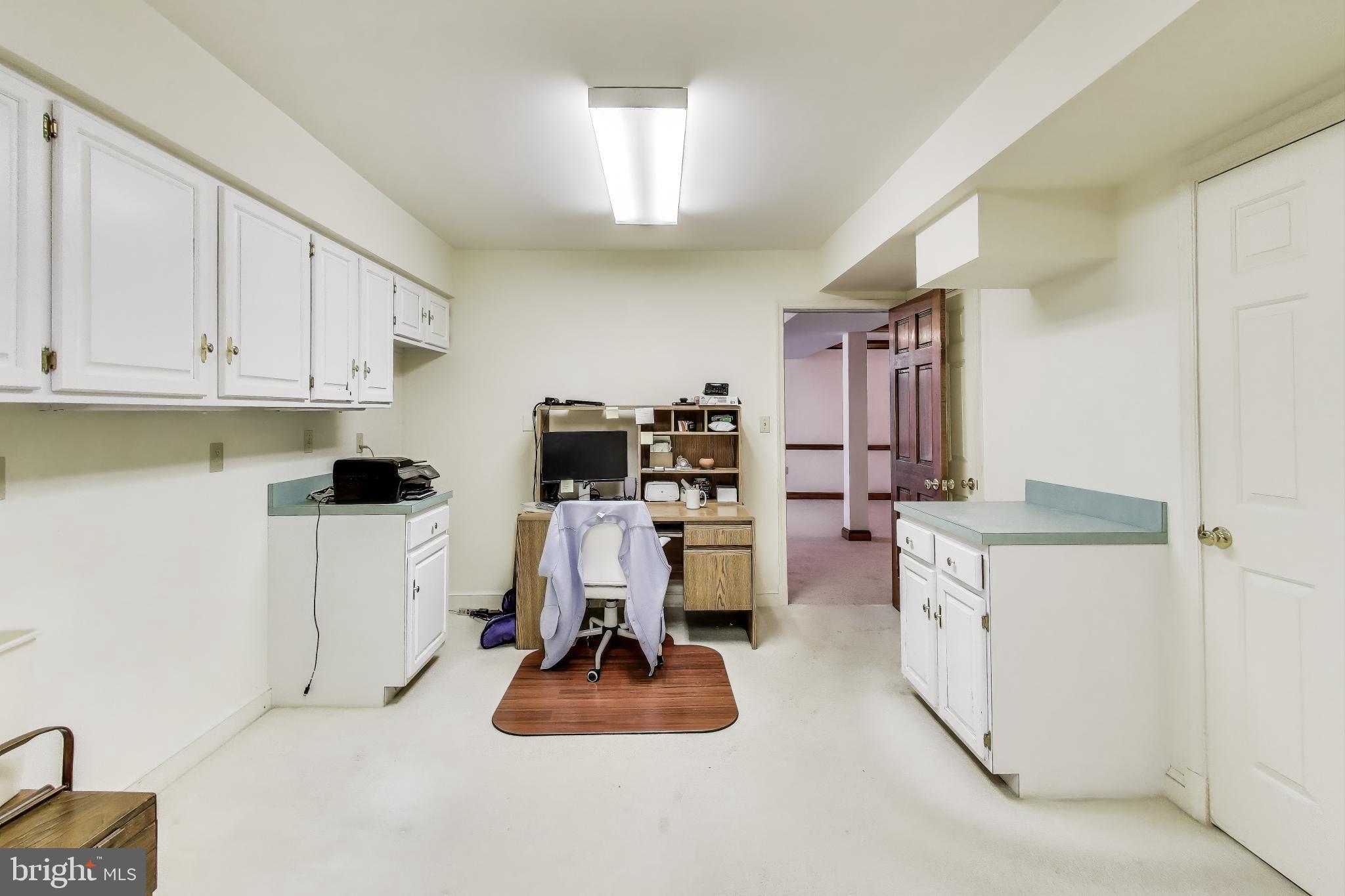 9201 Centerway Road Gaithersburg, MD 20879 - Photo 31 of 53 a kitchen with white cabinets and appliances