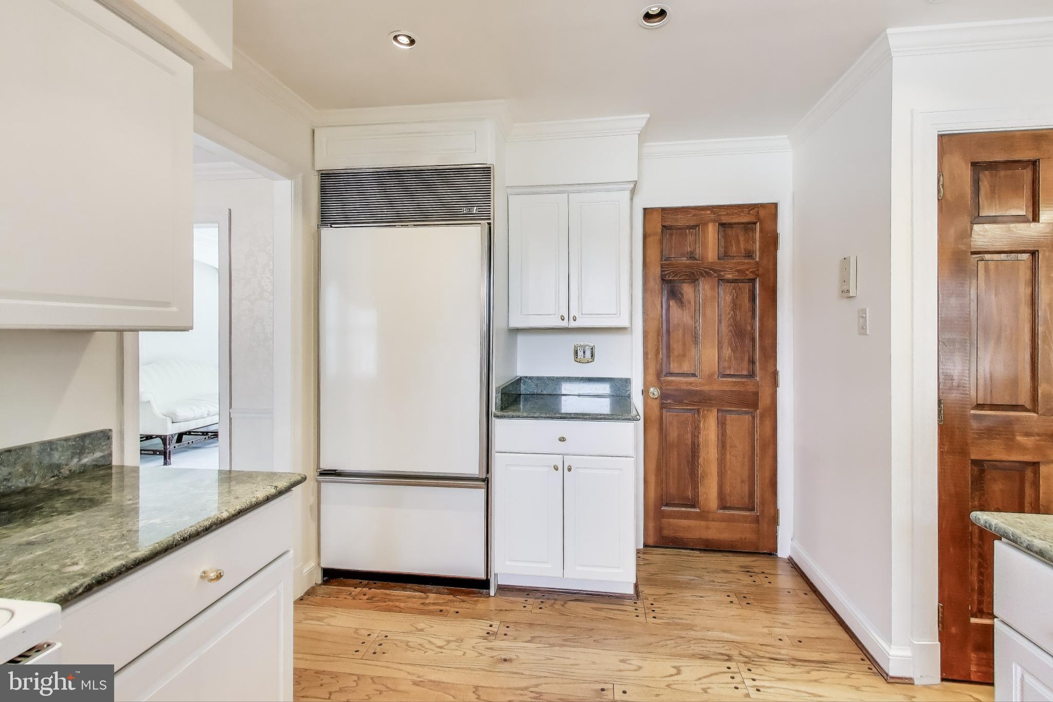 9201 Centerway Road Gaithersburg, MD 20879 - Photo 10 of 53 a kitchen with white cabinets and refrigerator