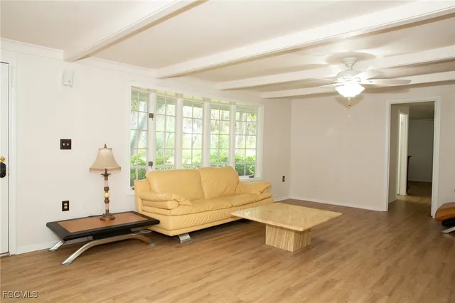 a living room with furniture a table and a chandelier
