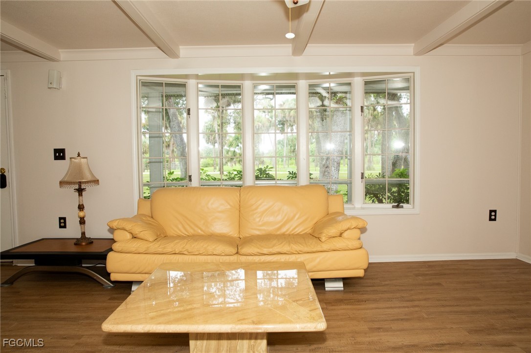 4055 County Road 78 Fort Denaud, FL 33935 - Photo 14 of 28 a living room with a large window and chandelier