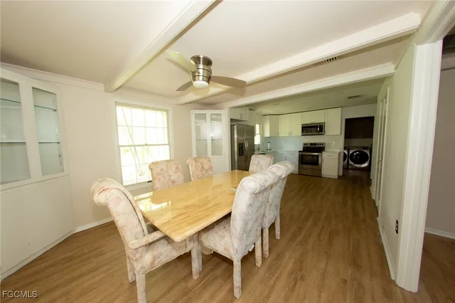 a view of a dining room with furniture and wooden floor