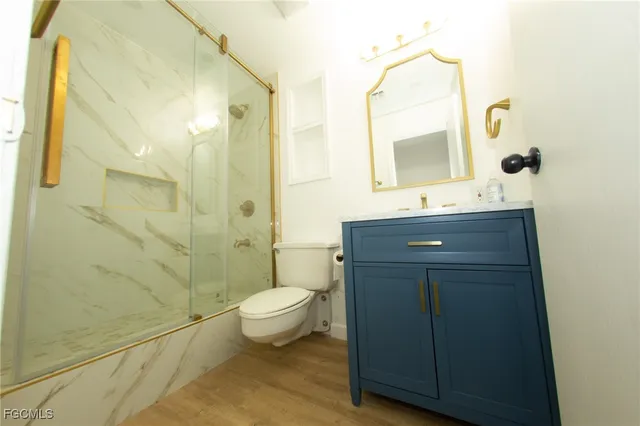 a bathroom with a sink mirror toilet and shower