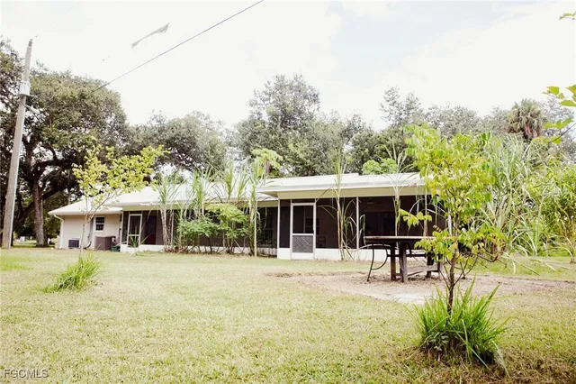 a view of a house with sitting area and garden