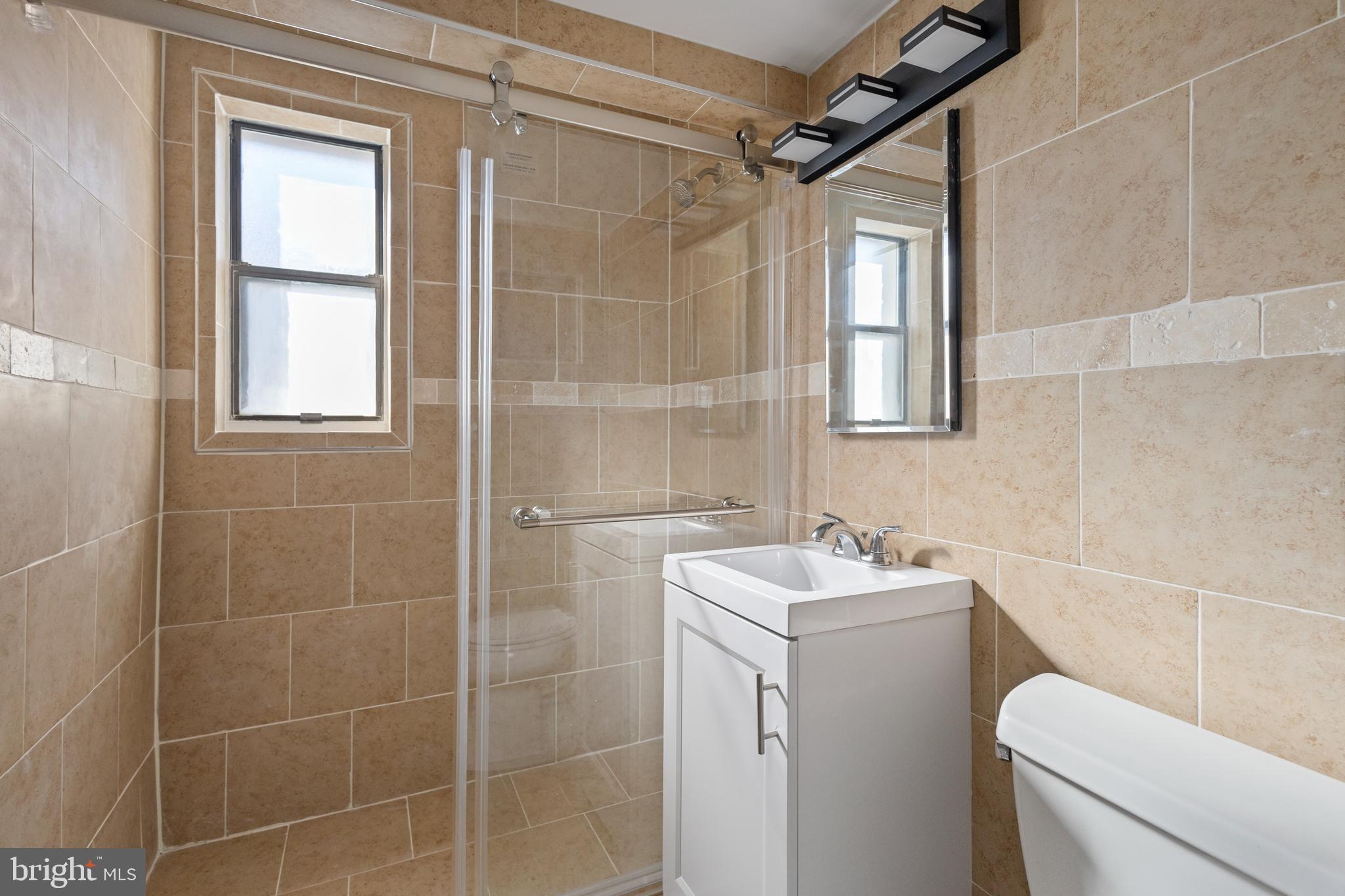 3825 Davis Place Northwest, Unit 103 Washington, DC 20007 - Photo 16 of 26 a bathroom with a sink toilet and shower