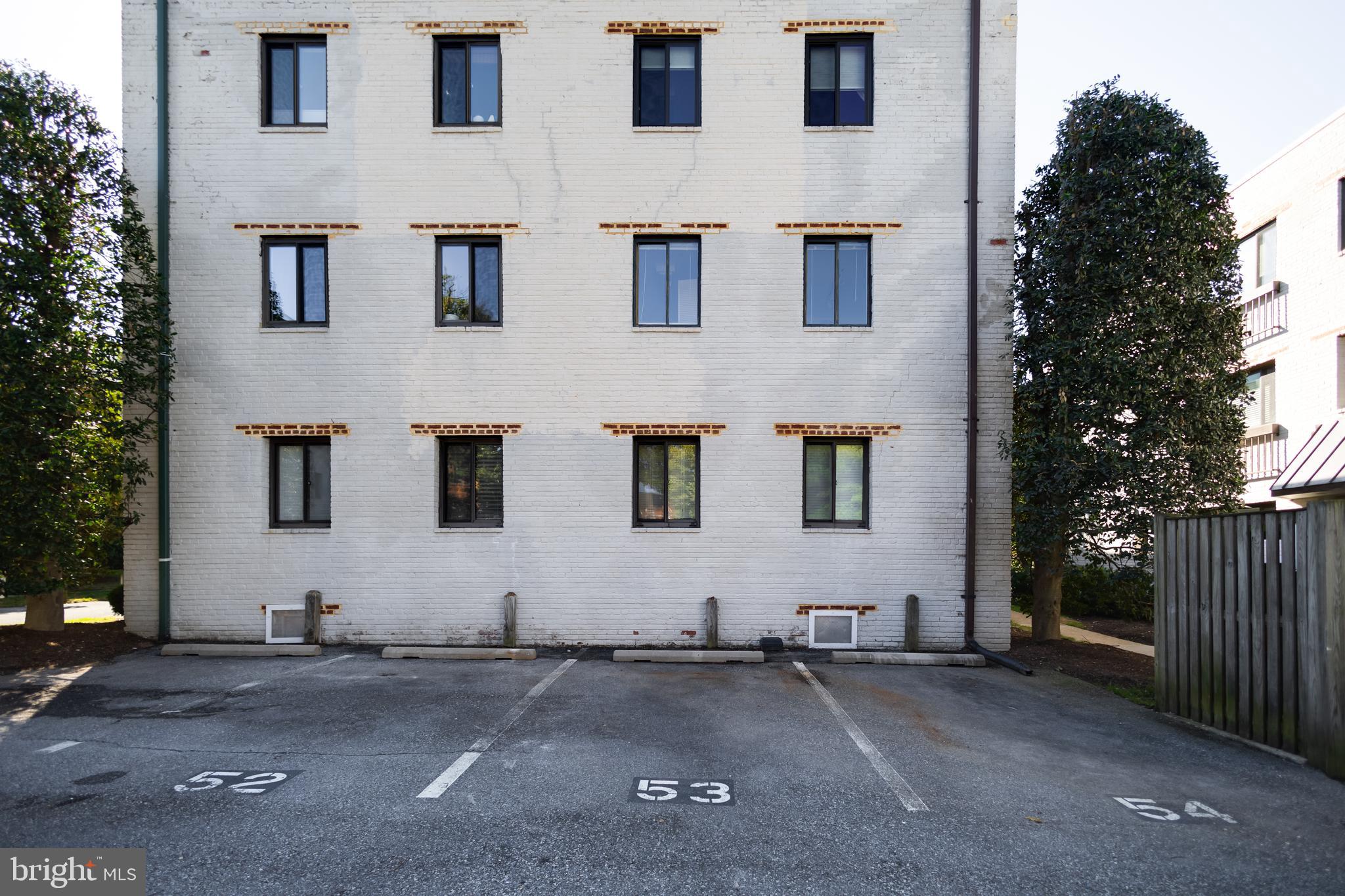 3825 Davis Place Northwest, Unit 103 Washington, DC 20007 - Photo 24 of 26 a view of a house with more windows and plants