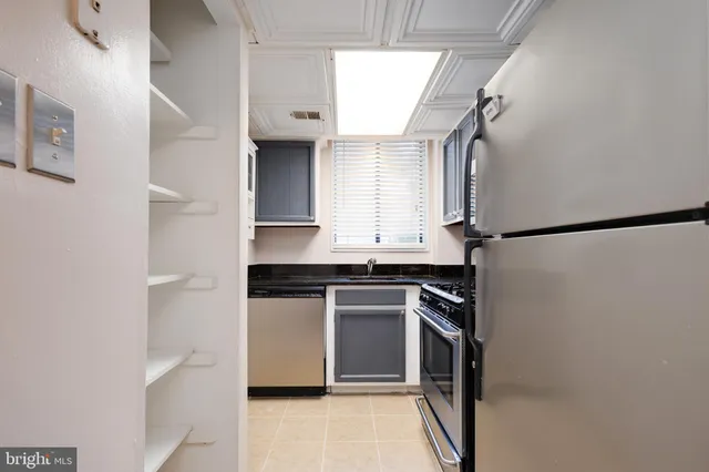 a kitchen with stainless steel appliances granite countertop a refrigerator and a sink