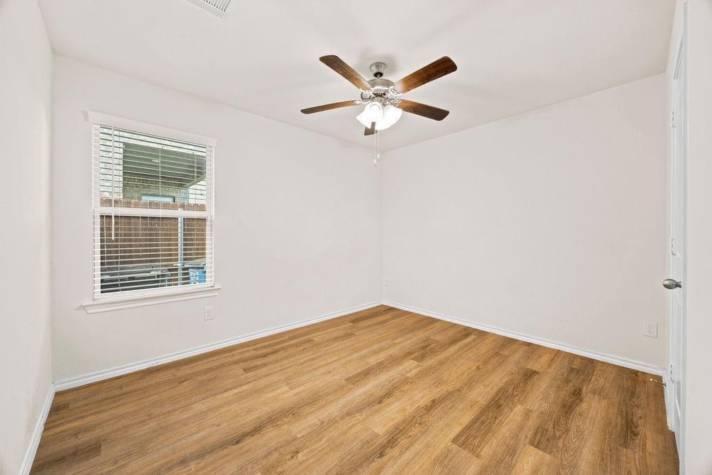 822 Ramble Road Lavon, TX 75166 - Photo 21 of 35 Bright room featuring wood-finish flooring and a ceiling fan with integrated lighting