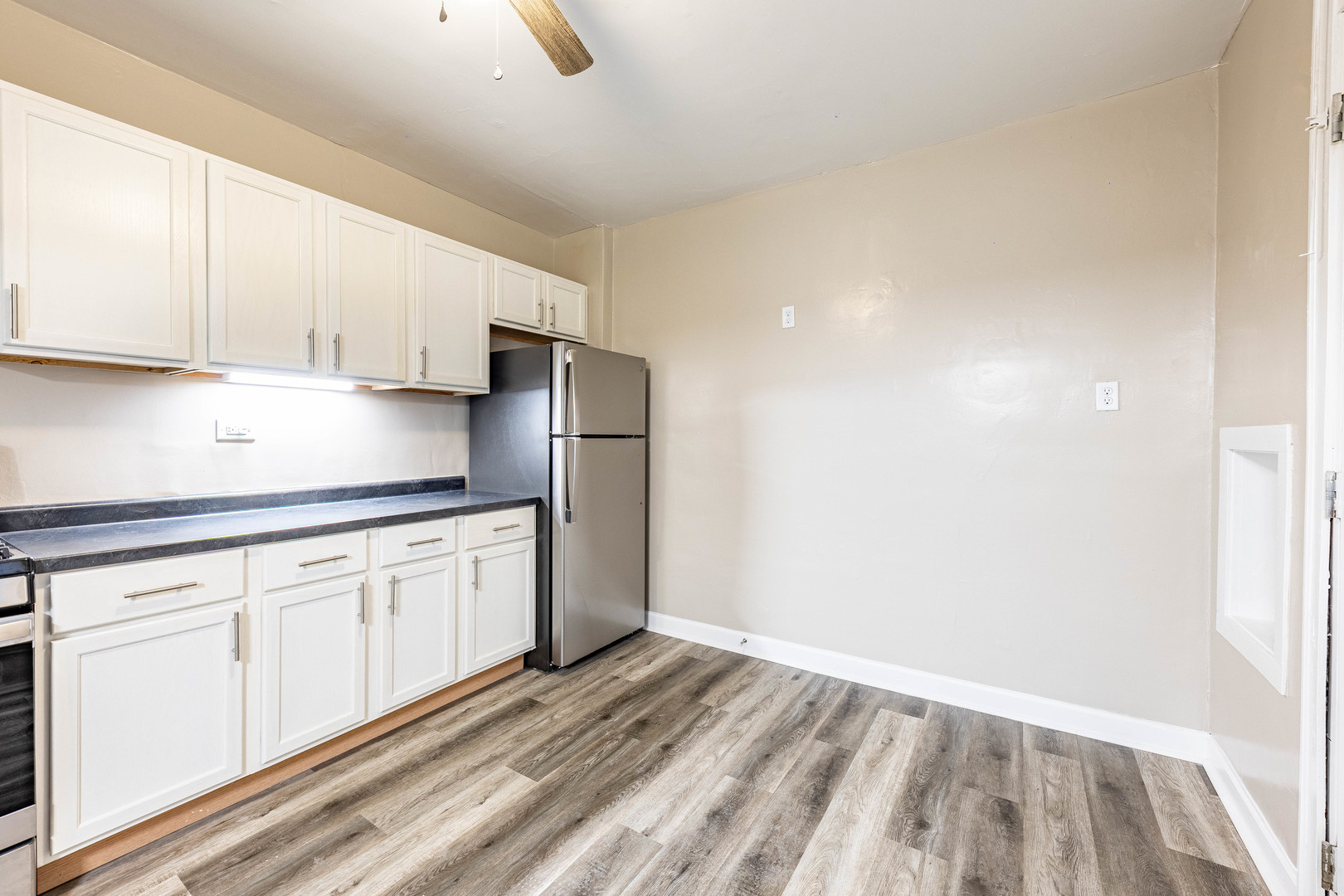 8401 South Paulina Street, Unit 1 Chicago, IL 60620 - Photo 13 of 17 a kitchen with granite countertop white cabinets and stainless steel appliances