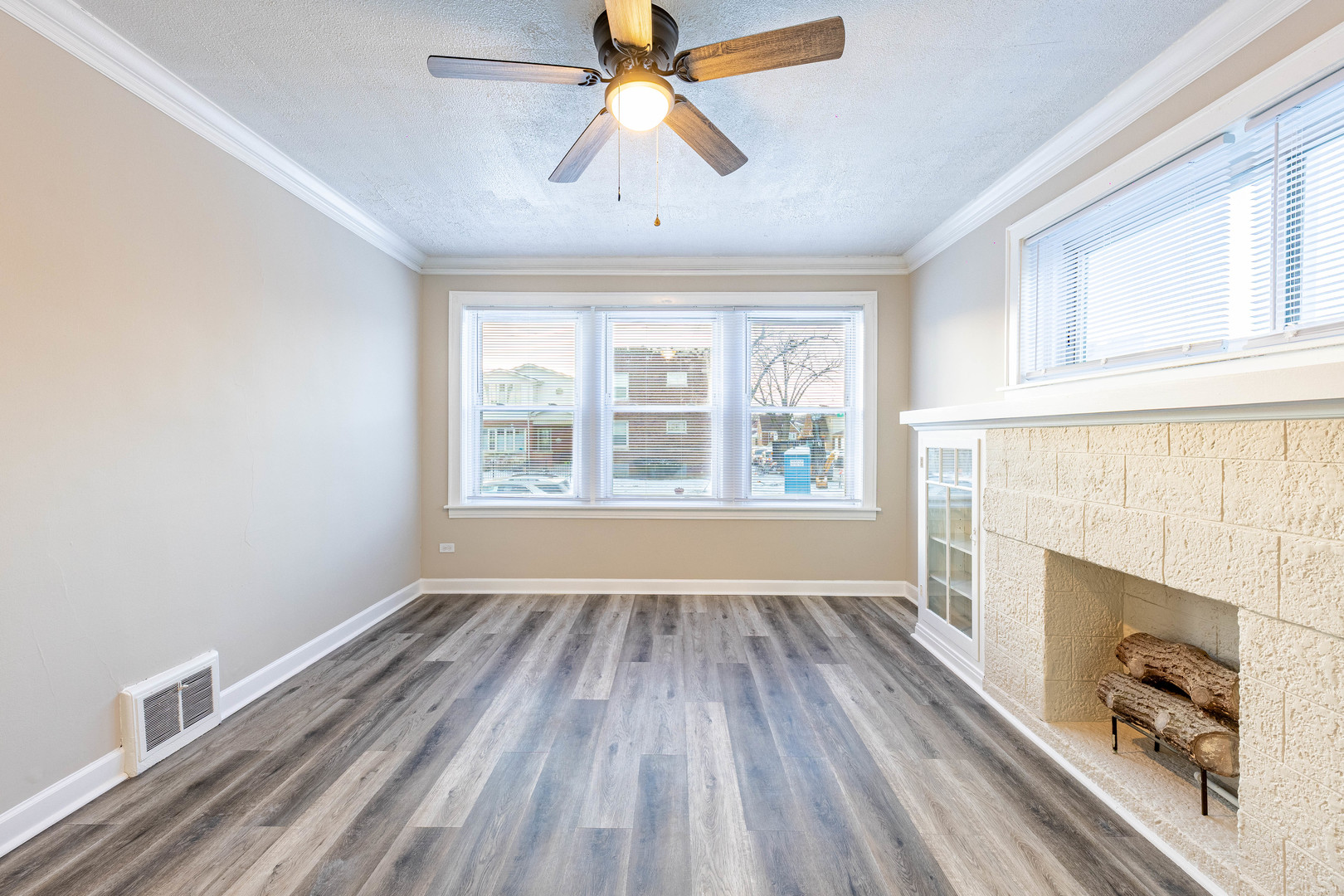 8401 South Paulina Street, Unit 1 Chicago, IL 60620 - Photo 5 of 17 wooden floor fireplace and windows in an empty room
