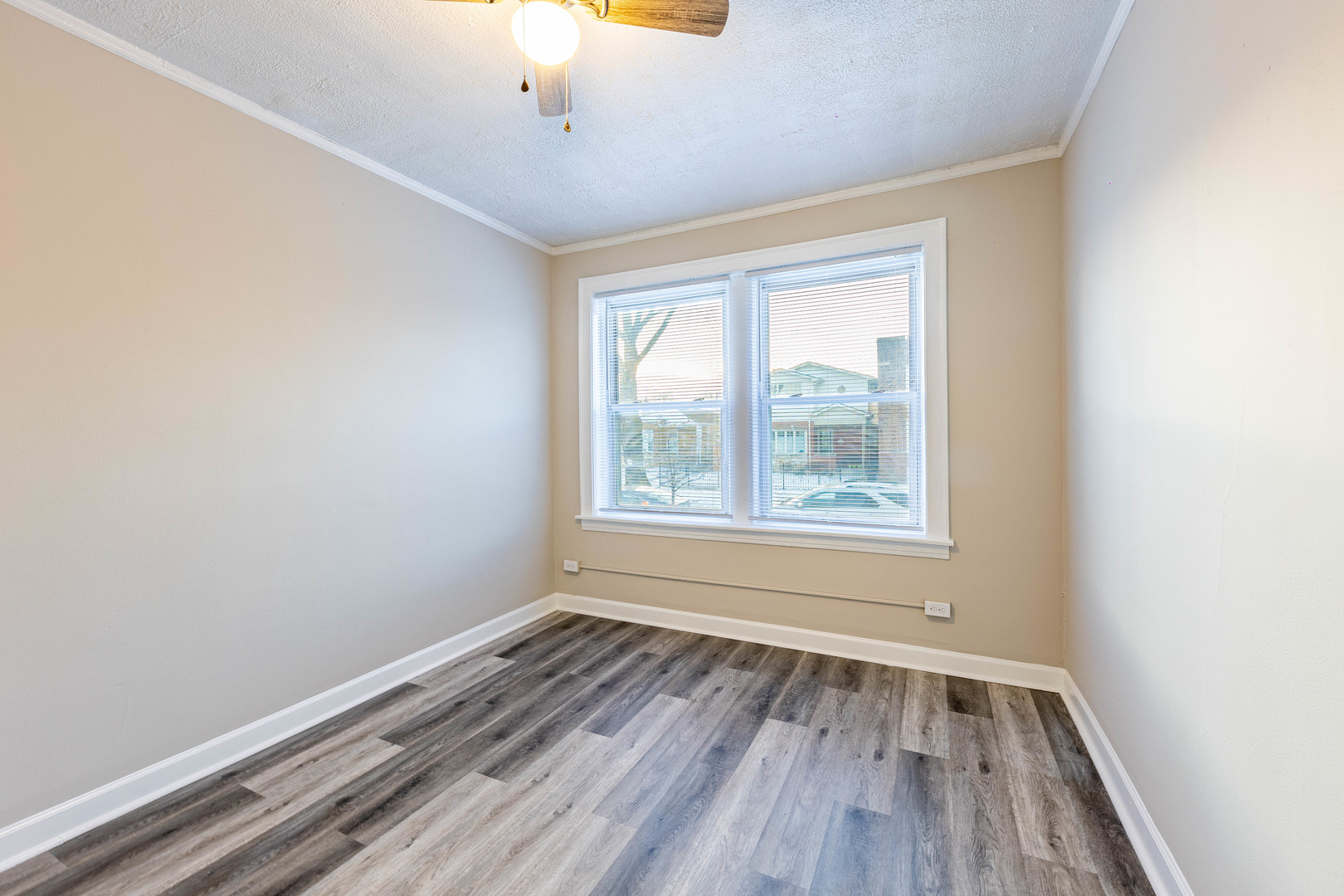 8401 South Paulina Street, Unit 1 Chicago, IL 60620 - Photo 8 of 17 a view of an empty room with wooden floor and a window