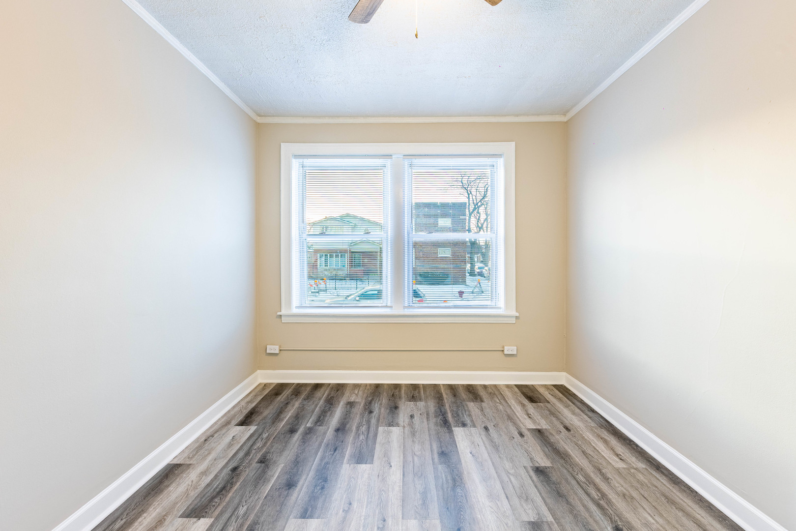 8401 South Paulina Street, Unit 1 Chicago, IL 60620 - Photo 9 of 17 an empty room with wooden floor and windows