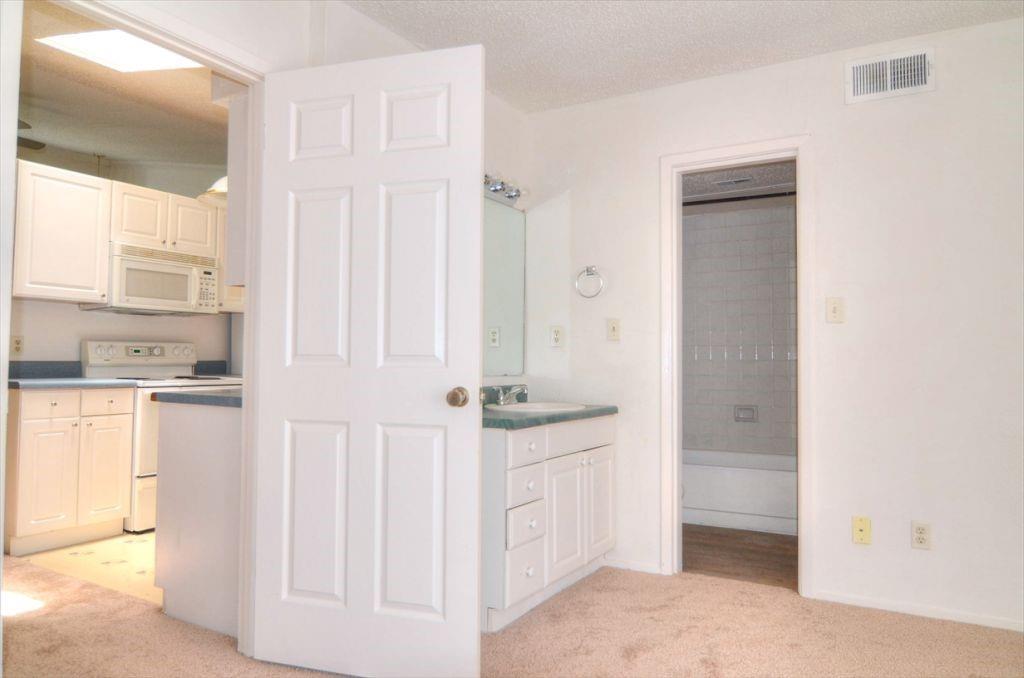 6503 Ridgecrest Road, Unit 110/J Dallas, TX 75231 - Photo 6 of 10 a bathroom with a sink and a mirror