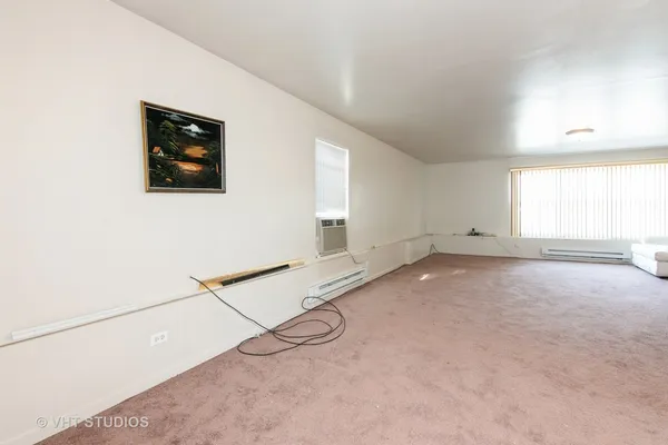 a view of a room with windows and closet