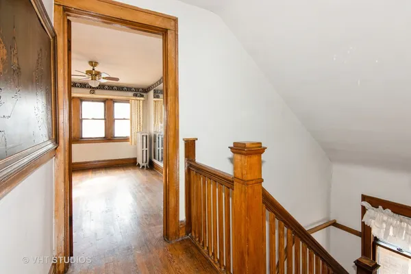 a view of a hallway view with wooden floor and staircase