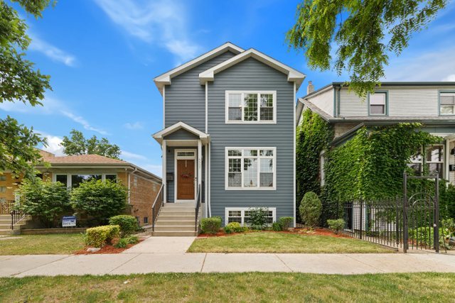 Undisclosed Address Chicago, IL 60634 - Photo 1 of 44 a front view of a house with a yard