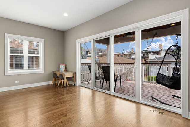 Undisclosed Address Chicago, IL 60634 - Photo 14 of 44 a dining room with furniture and a floor to ceiling window