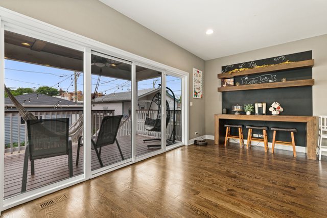 Undisclosed Address Chicago, IL 60634 - Photo 15 of 44 a dining room with wooden floor a glass table and chairs