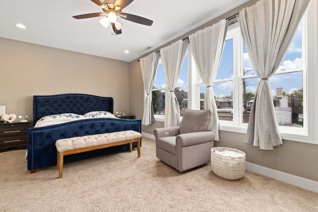 Undisclosed Address Chicago, IL 60634 - Photo 17 of 44 a bedroom with furniture and a large window