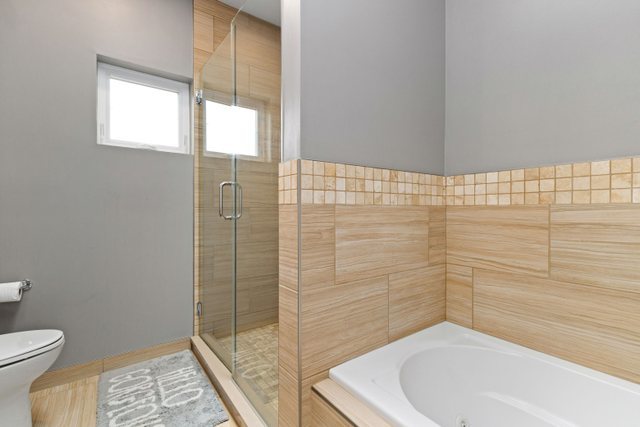 Undisclosed Address Chicago, IL 60634 - Photo 20 of 44 a bathroom with a bathtub and shower