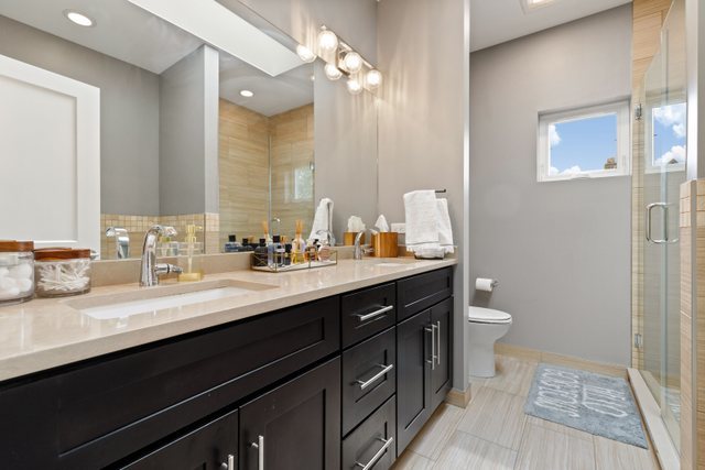 Undisclosed Address Chicago, IL 60634 - Photo 21 of 44 a bathroom with a sink double vanity and a toilet