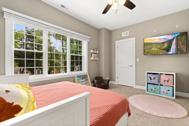 Undisclosed Address Chicago, IL 60634 - Photo 24 of 44 a bedroom with a bed and a large window