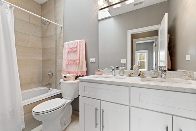 Undisclosed Address Chicago, IL 60634 - Photo 25 of 44 a bathroom with a sink toilet tub and shower