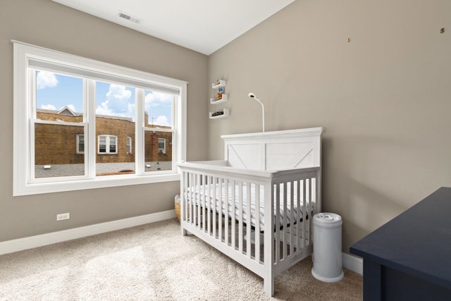 Undisclosed Address Chicago, IL 60634 - Photo 26 of 44 a bedroom with a bed and window