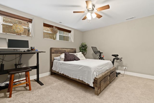 Undisclosed Address Chicago, IL 60634 - Photo 30 of 44 a bedroom with a bed and a desk