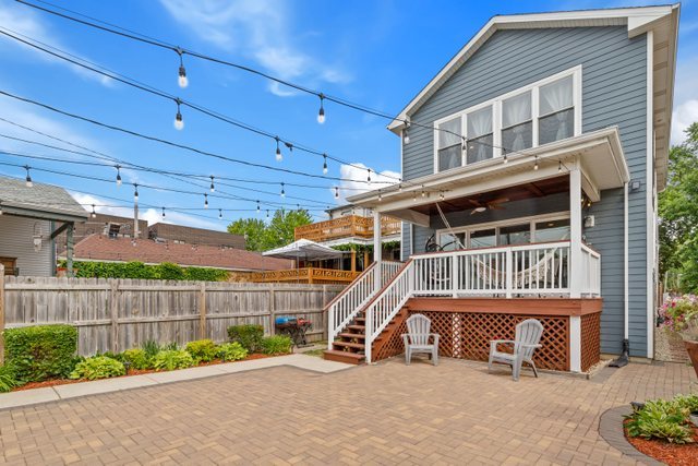 Undisclosed Address Chicago, IL 60634 - Photo 35 of 44 a view of a house with a small yard and wooden fence