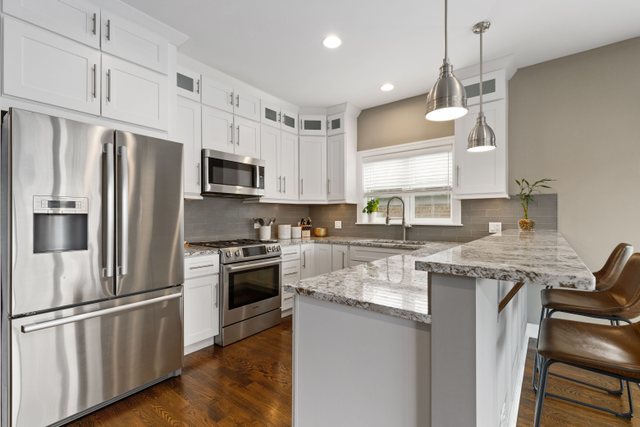 Undisclosed Address Chicago, IL 60634 - Photo 10 of 44 a kitchen with stainless steel appliances granite countertop a refrigerator a stove a sink and a microwave