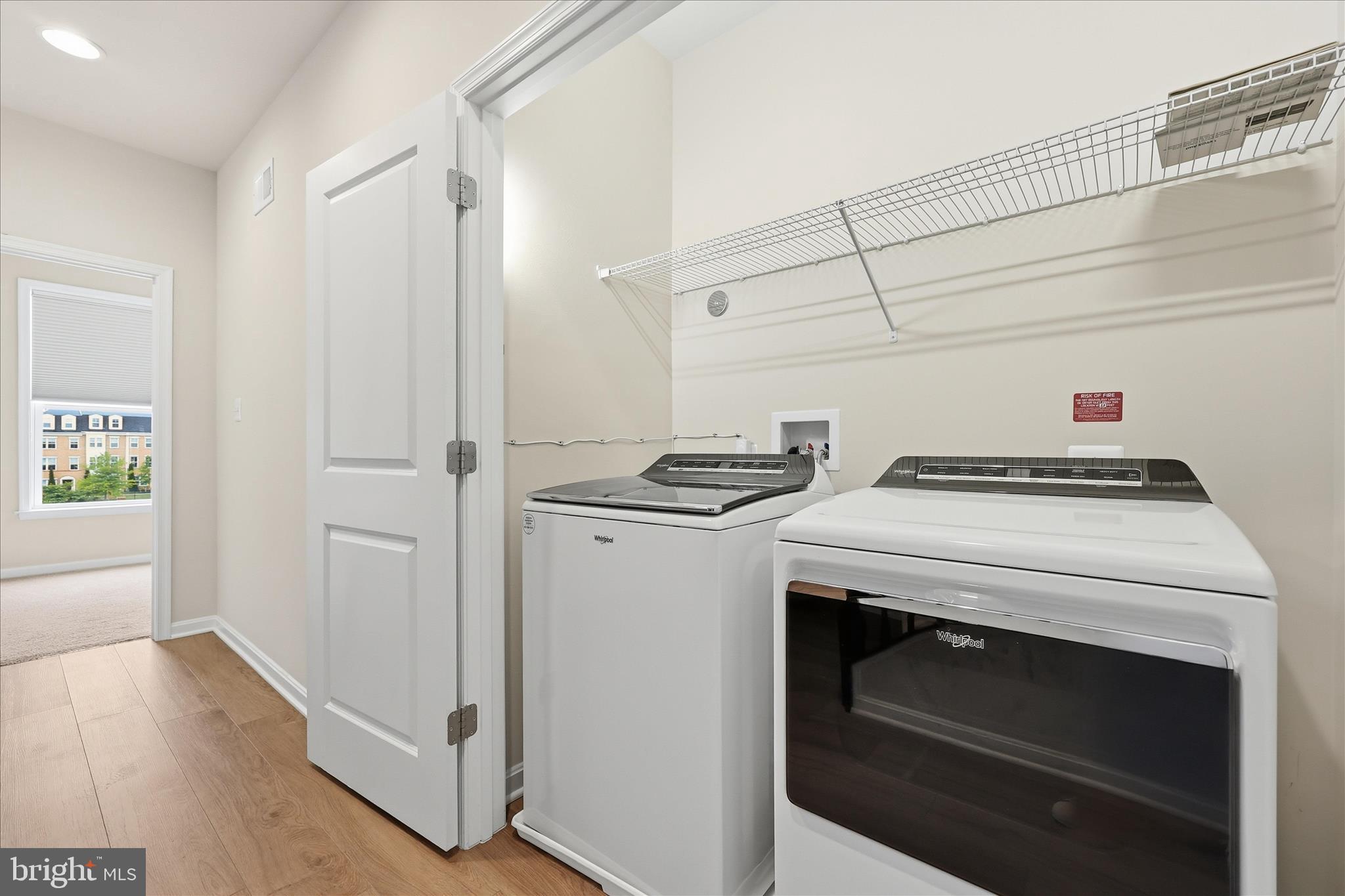 1090 Holden Road Frederick, MD 21701 - Photo 26 of 60 a view of washer and dryer with kitchen in the background